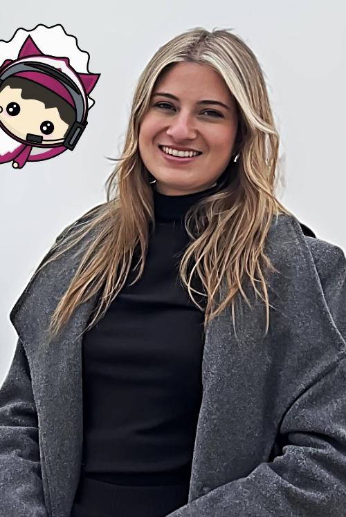 Portrait of a smiling team member in a gray coat